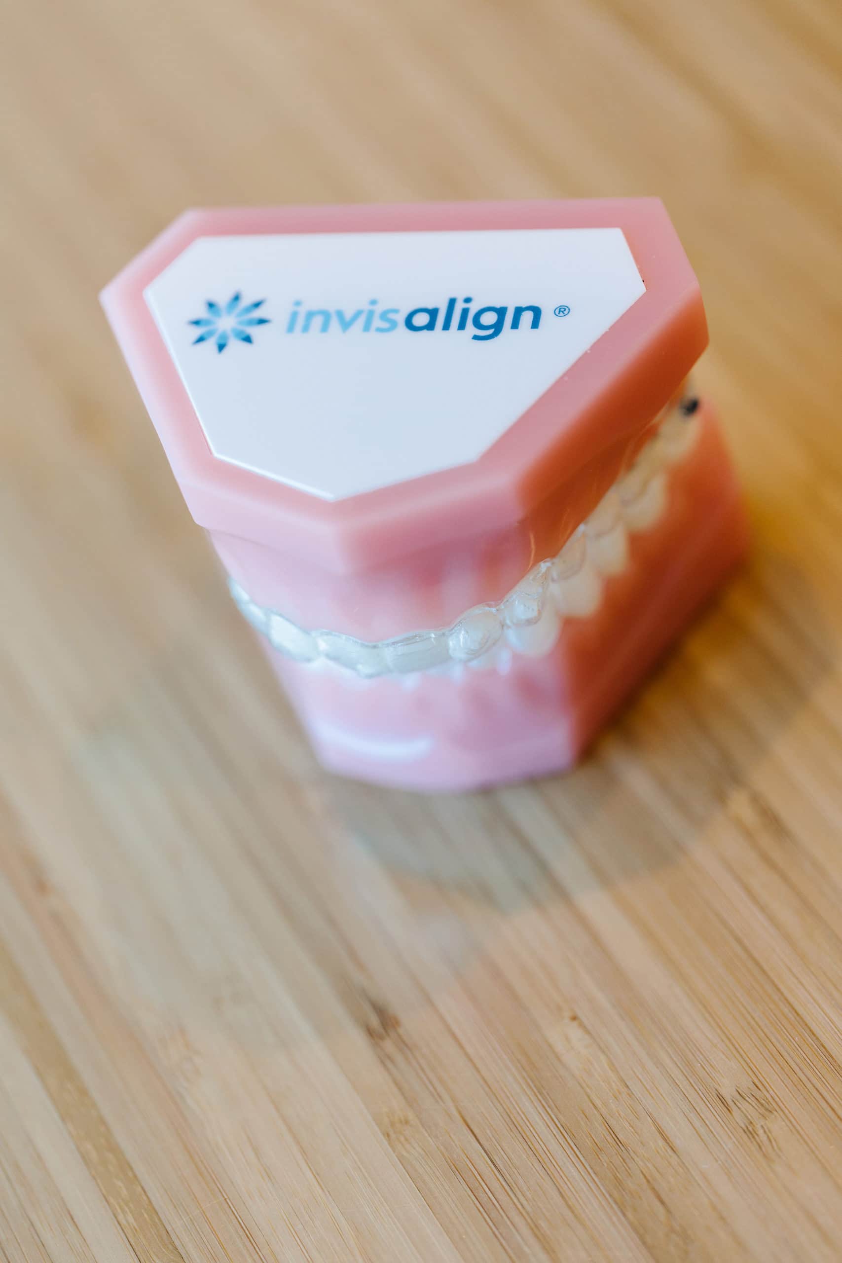 Plastic model of teeth with Invisalign clear aligners.