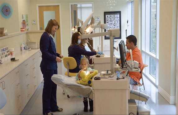 an orthodontist caring for a child patient