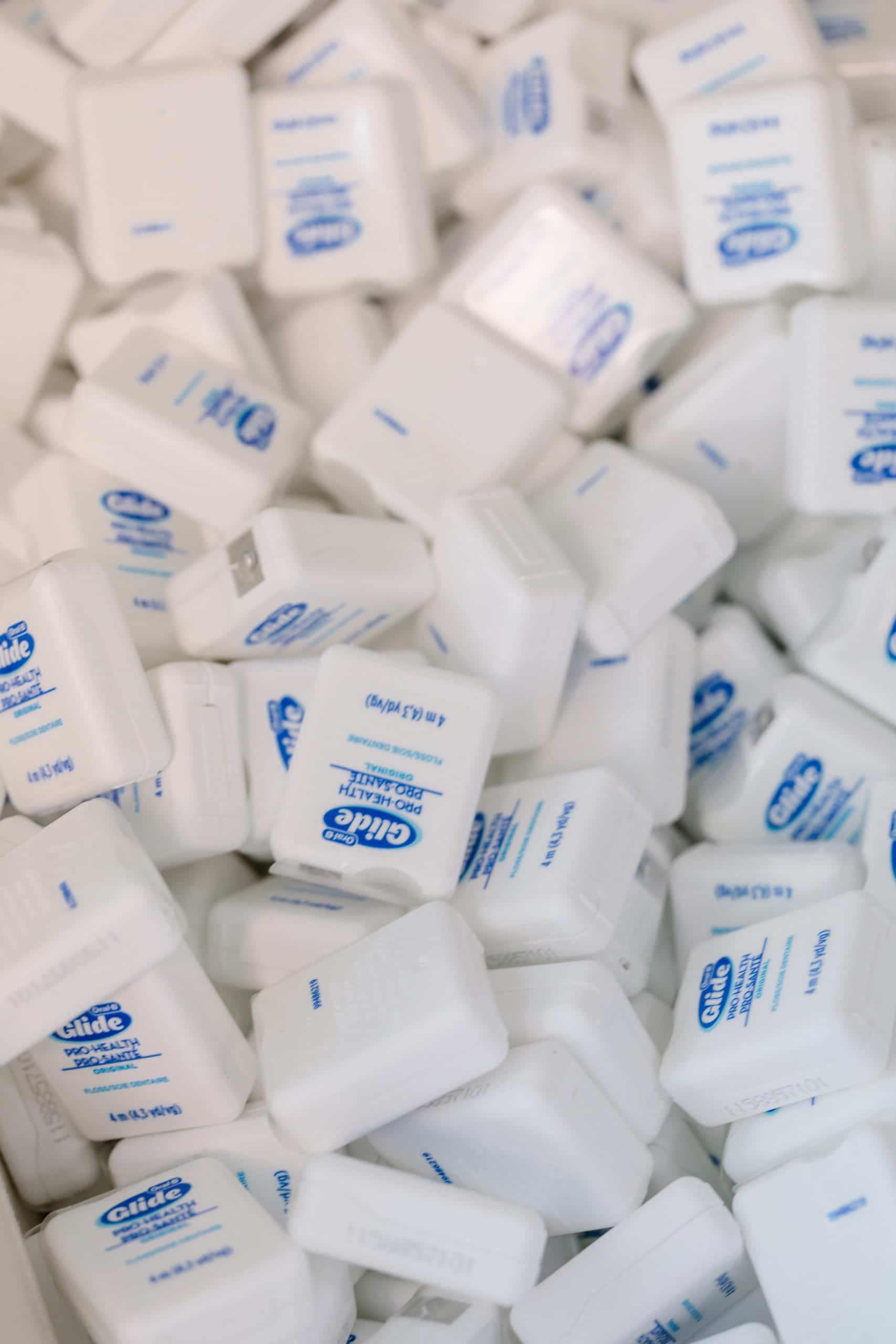 A large bin full of Oral B floss.