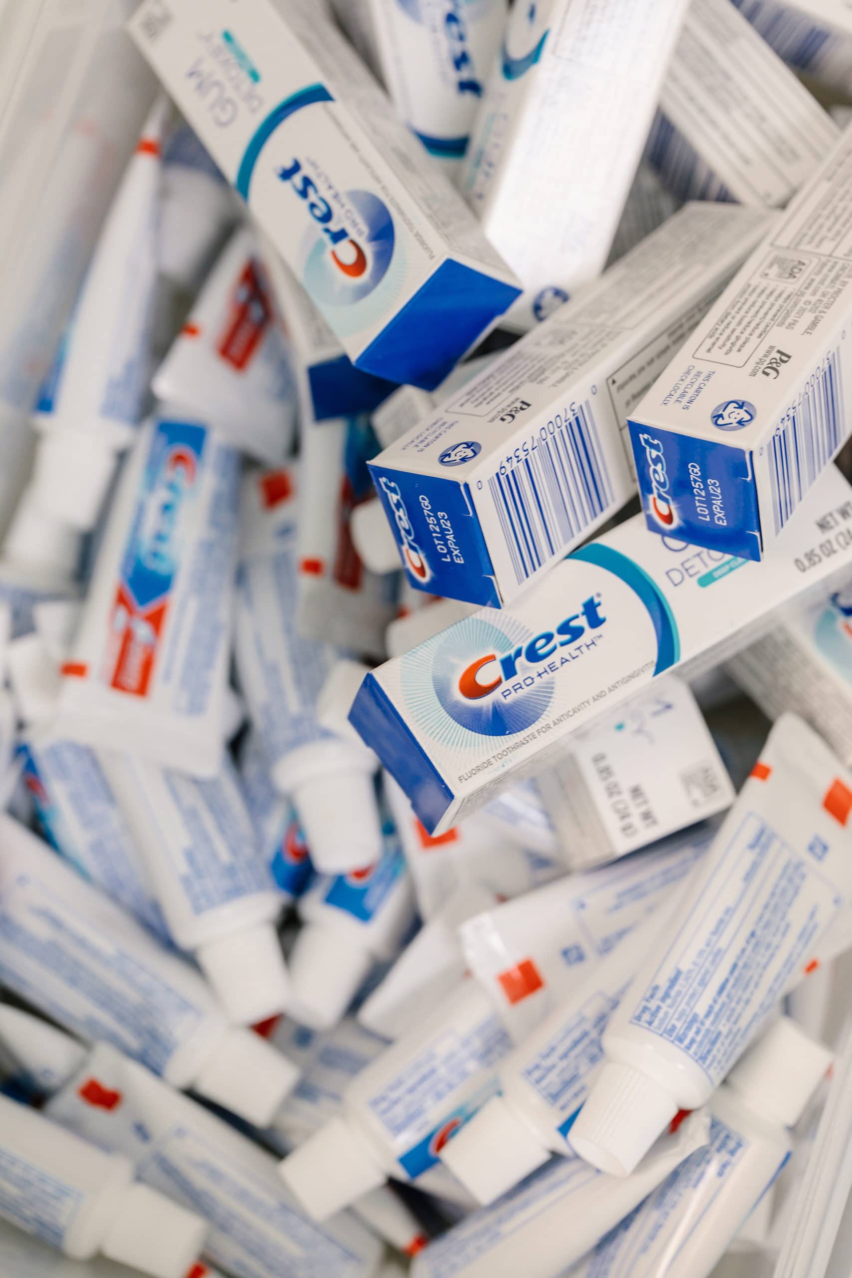 A large bin full of travel size Crest Pro Health toothpastes.
