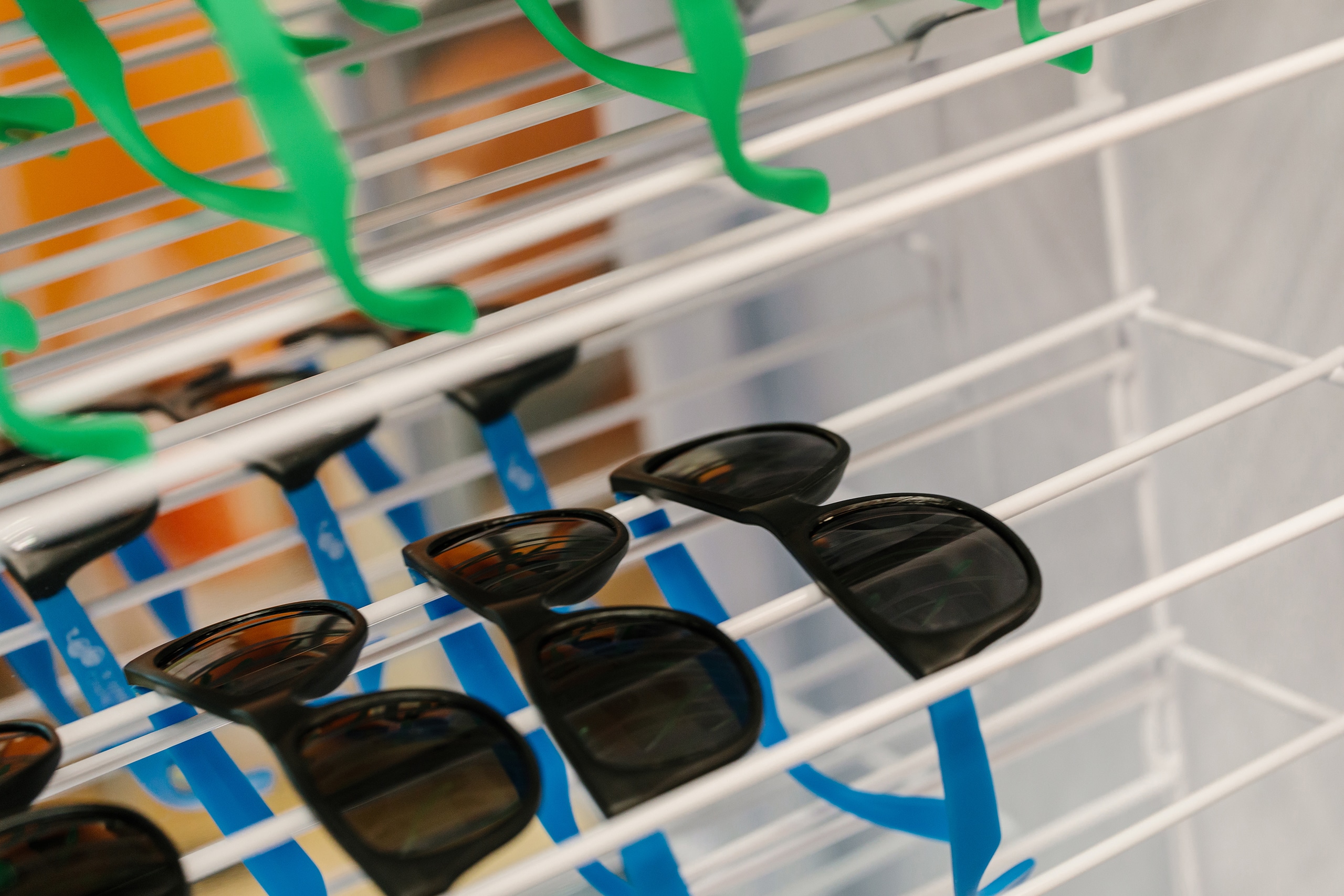 A rack with many pairs of sunglasses.