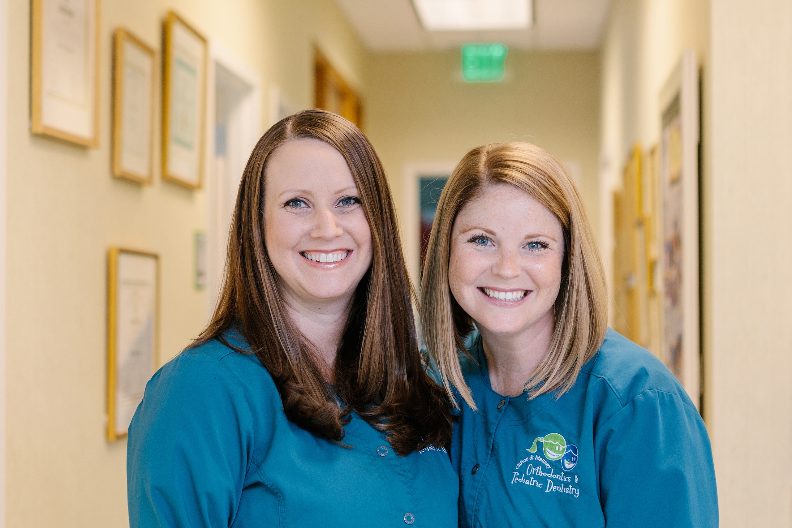 two Clifton and Mauney orthodontic specialist smiling for a picture