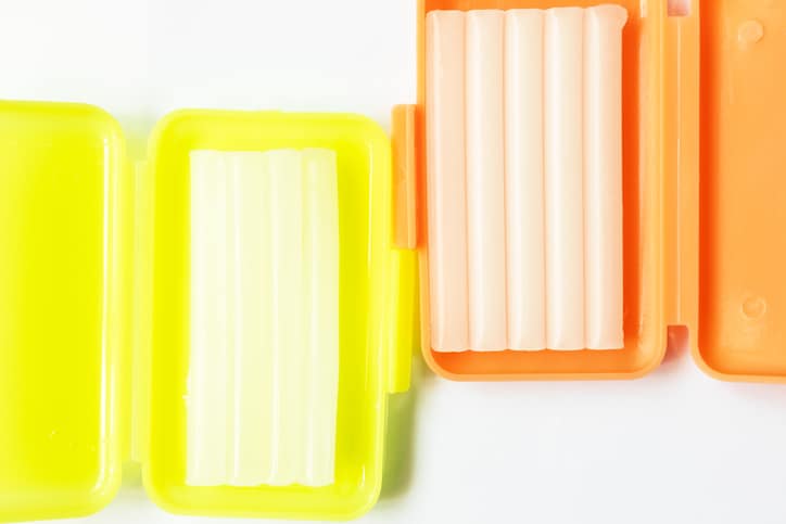 yellow and orange braces wax in their corresponding case