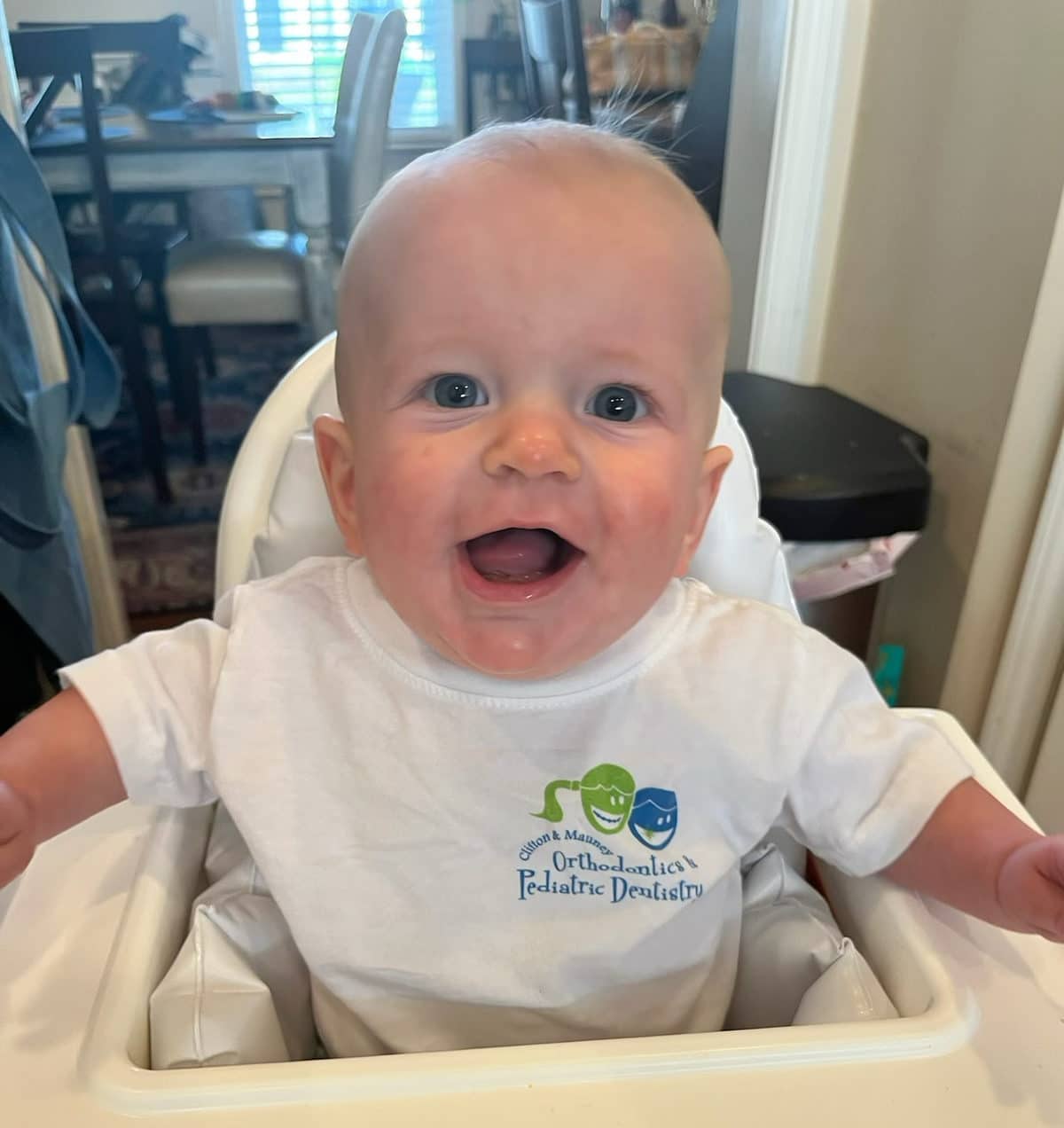 a baby wearing a clifton and mauney pediatric dentistry shirt
