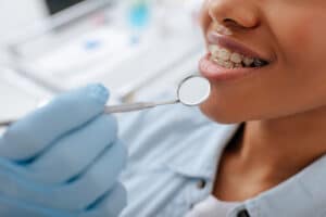 a patient with braces is examined at the dentist