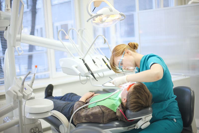 Dentist does dental work on a child during sedation dentistry