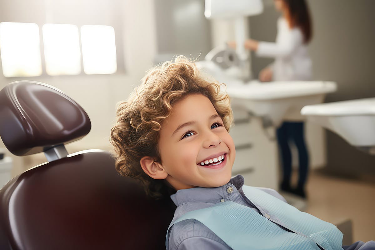 Boy smiling in dentist chair