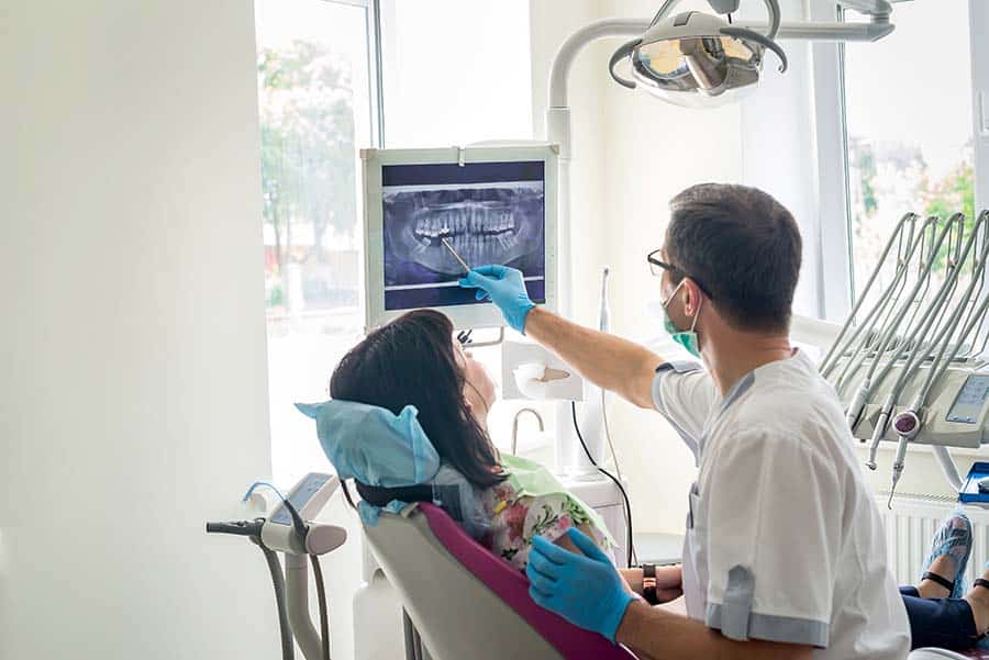 woman speaking to her dentist during a visit
