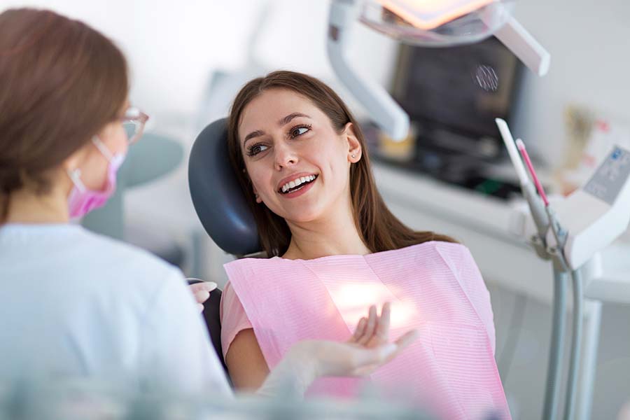 woman speaking to her dentist about her care