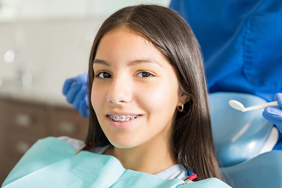 a teen girl smiling with Damon braces