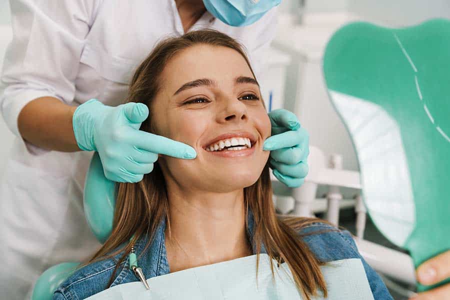 woman smiling after her dental visit