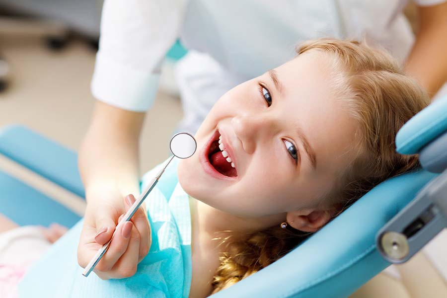 a little girl smiling about to receive sedation dentistry