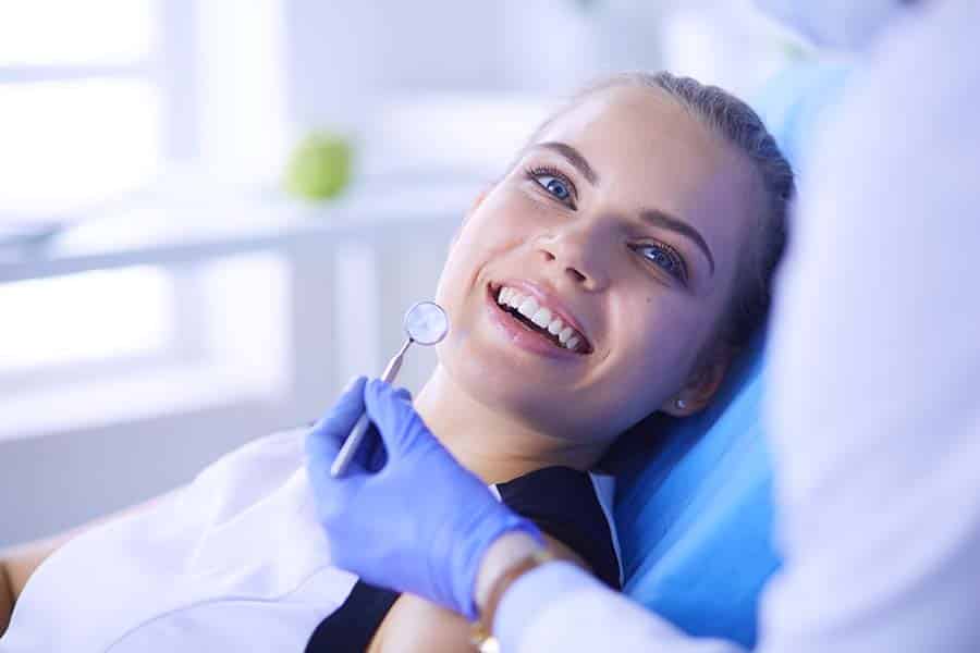 Woman smiling during her dental examination