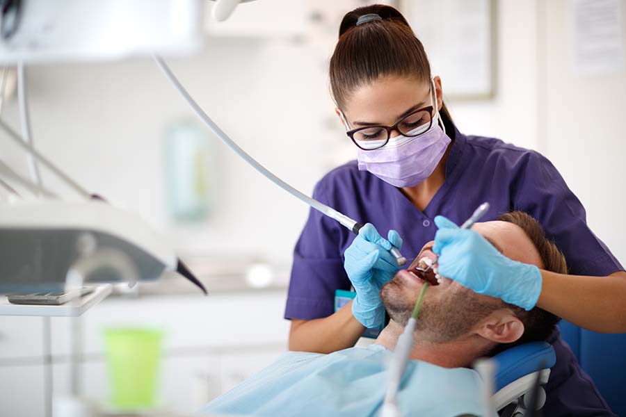 man receiving dental care before giving feedback about his visit