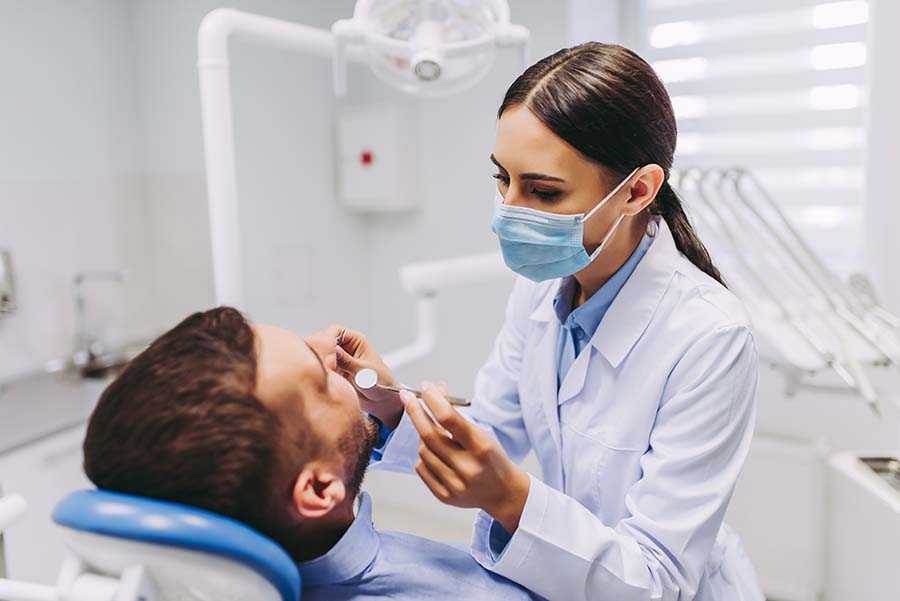 Man receiving consultation for oral surgery and endodontic treatment