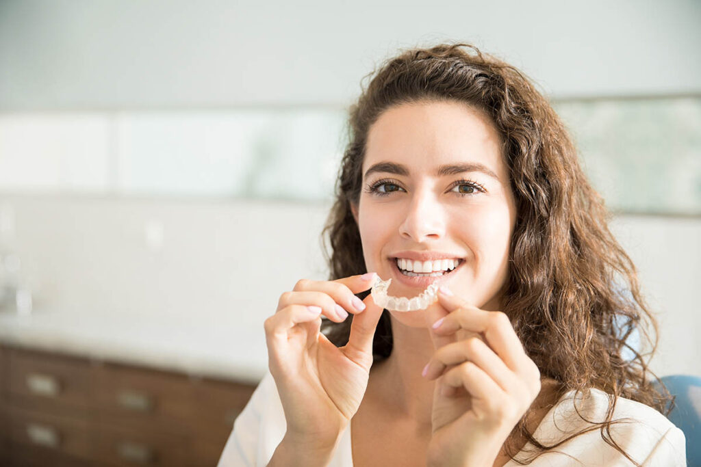 an adult prepares to start wearing clear braces