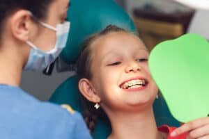 an orthodontist tells a young client how to make retainers more comfortable