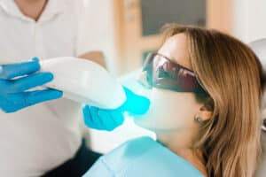 a child receives fluoride treatment at the dentist