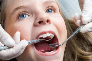 a child has her teeth examined by a pediatric dentist in chapel hill