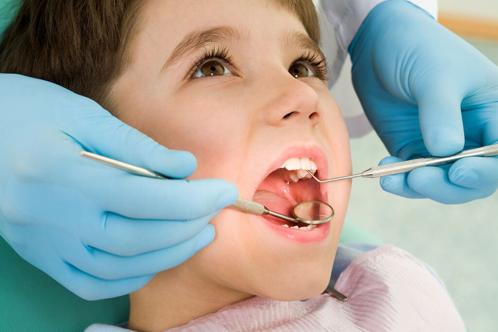 a childs teeth are examined after a pediatric dental emergency