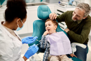 a child and his parent visit the pediatric dentist