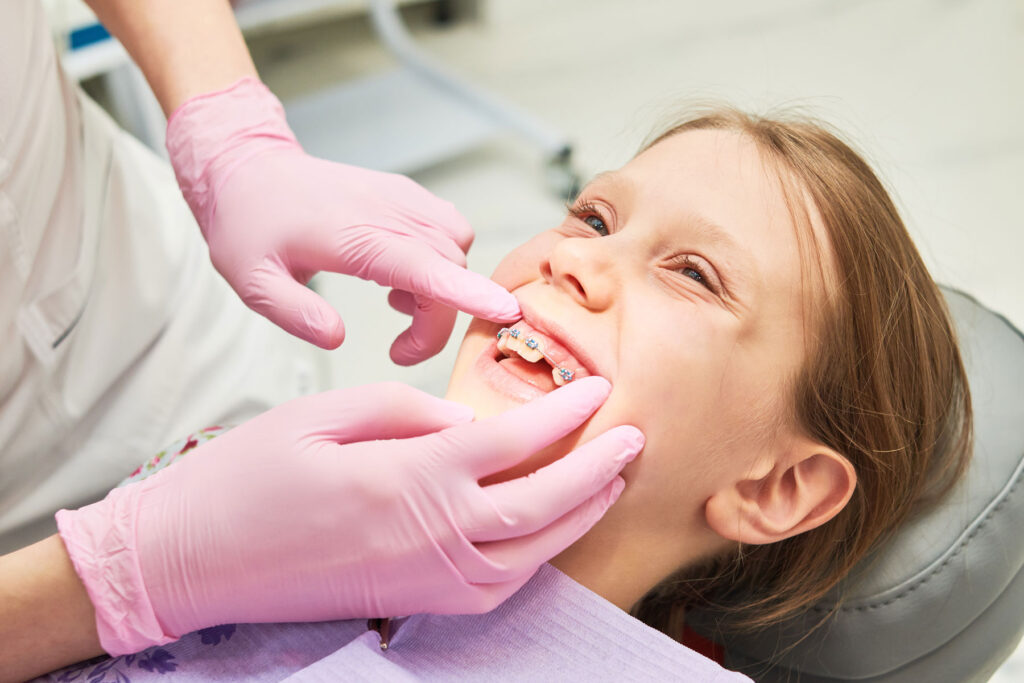 a child is fitted for braces at the orthodontist