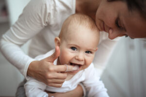 Mother brushing baby's teeth