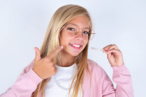 Girl pointing to Invisalign
